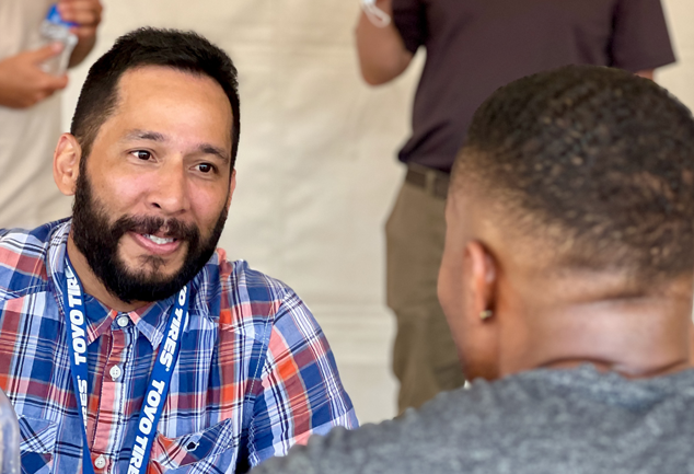 Two people talking face to face.